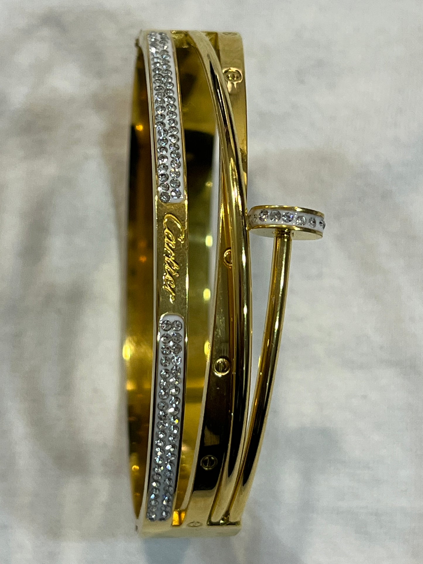 Cartier Elegant Gold Bracelet with Sparkling Stone Accents