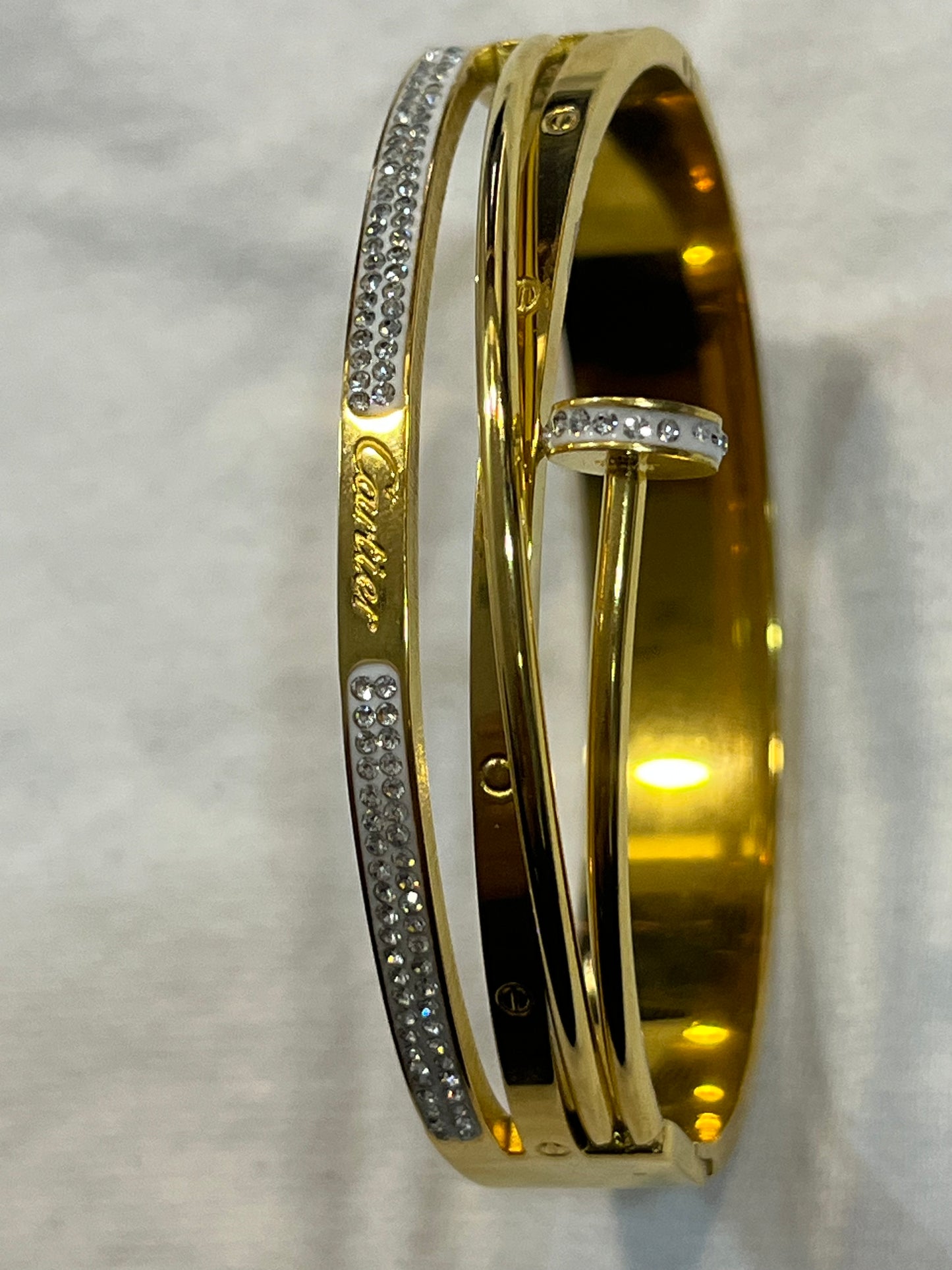 Cartier Elegant Gold Bracelet with Sparkling Stone Accents